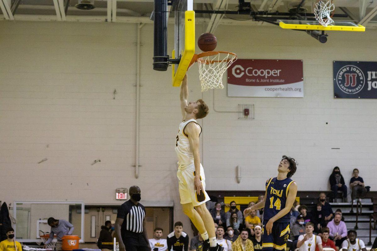 Connor Dickerson puts in a layup. Dickerson is one of the three returning seniors on the men's basketball team. Wednesday, Jan. 19, 2022. - Multimedia Editor / Lee Kotzen