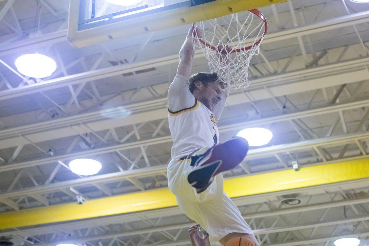 Connor Dickerson dunks the ball. Dickerson is one of the clear leaders on Rowan men's basketball. Tuesday, November 8, 2022. - Multimedia Editor / Lee Kotzen