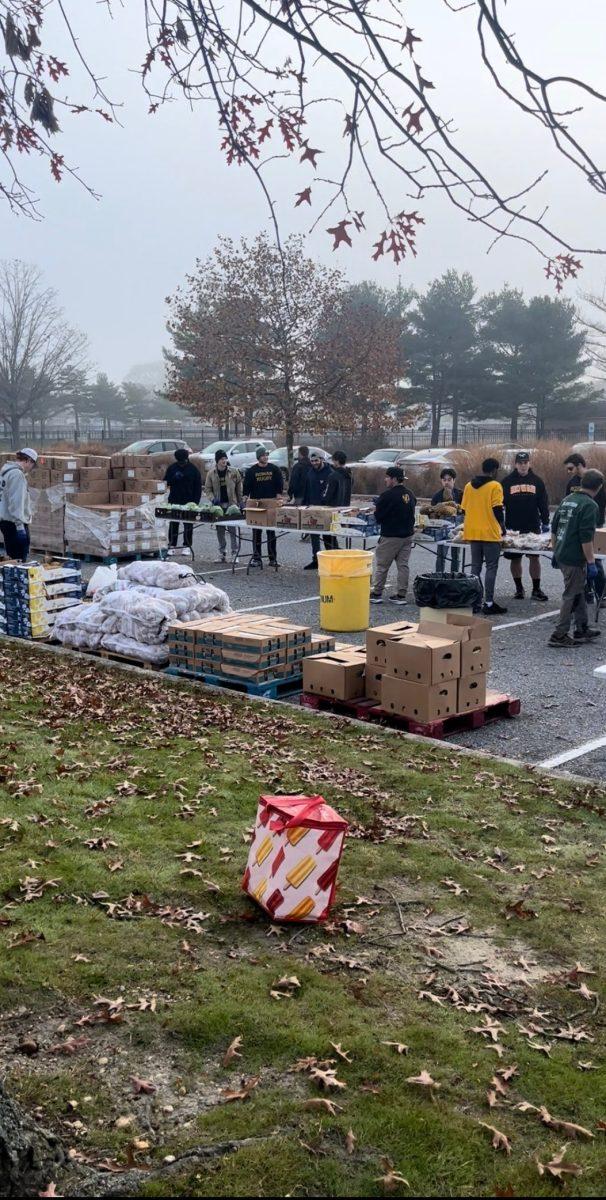 Volunteers unload produce and prepare bags of food for the drive-thru method of distribution. - Staff Writer / Morgan Reitzel 