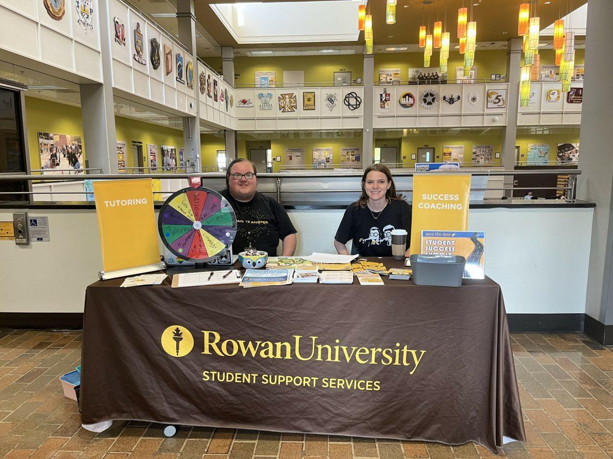 The Student Support Services Street Team sit in the Student Center with the "wheel of success." - Photo / Rowan Student Success Programs