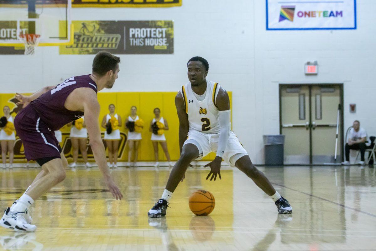 Marcellus Ross dribbles the ball between his legs. Ross helped led the way to victory over Ramapo. Tuesday, Nov. 8, 2022. - Multimedia Editor / Lee Kotzen