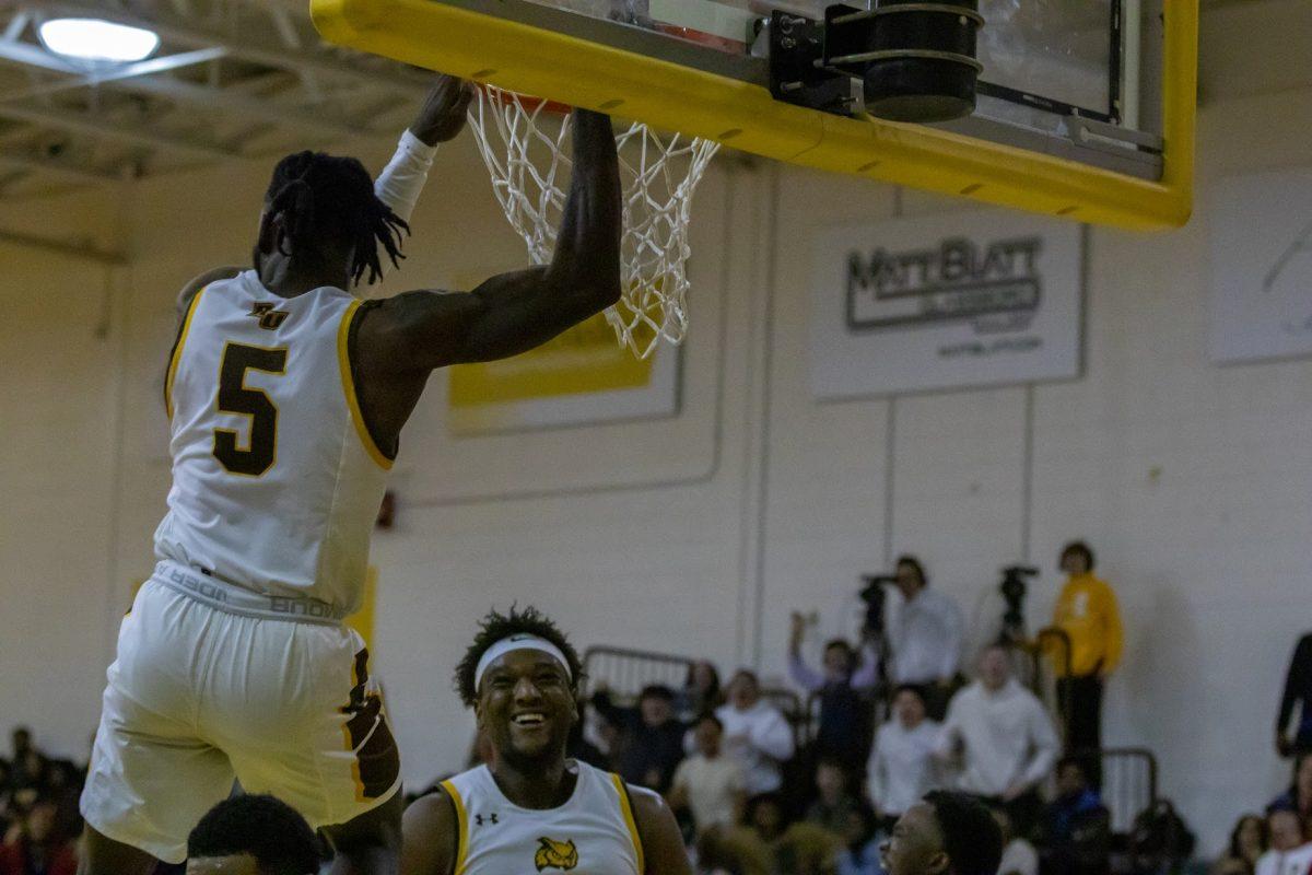 D'Andre Vilmar hangs on the rim after an alley-oop. Vilmar helped lead the defense to victory against TCNJ. Wednesday, Jan. 18, 2023. - Multimedia Editor / Lee Kotzen