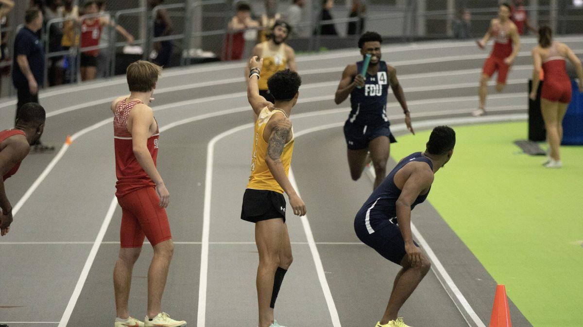 A Rowan track member waits for patton in relay race. The relay race was one of the eight first place finishes st the Alvernia Winter Invitational. Friday, Jan. 20. - Photo / Dom Francesconi via Rowan Athletics