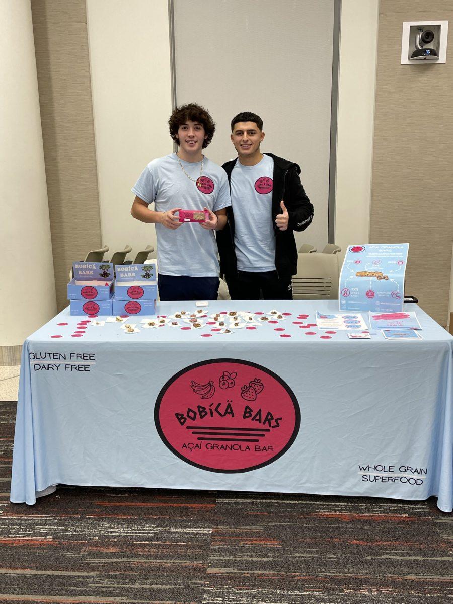 Harrison Nastasi and his friend Joey Vella man a Bobica Bars stand in the Business Hall. - Photo / Harrison Nastasi