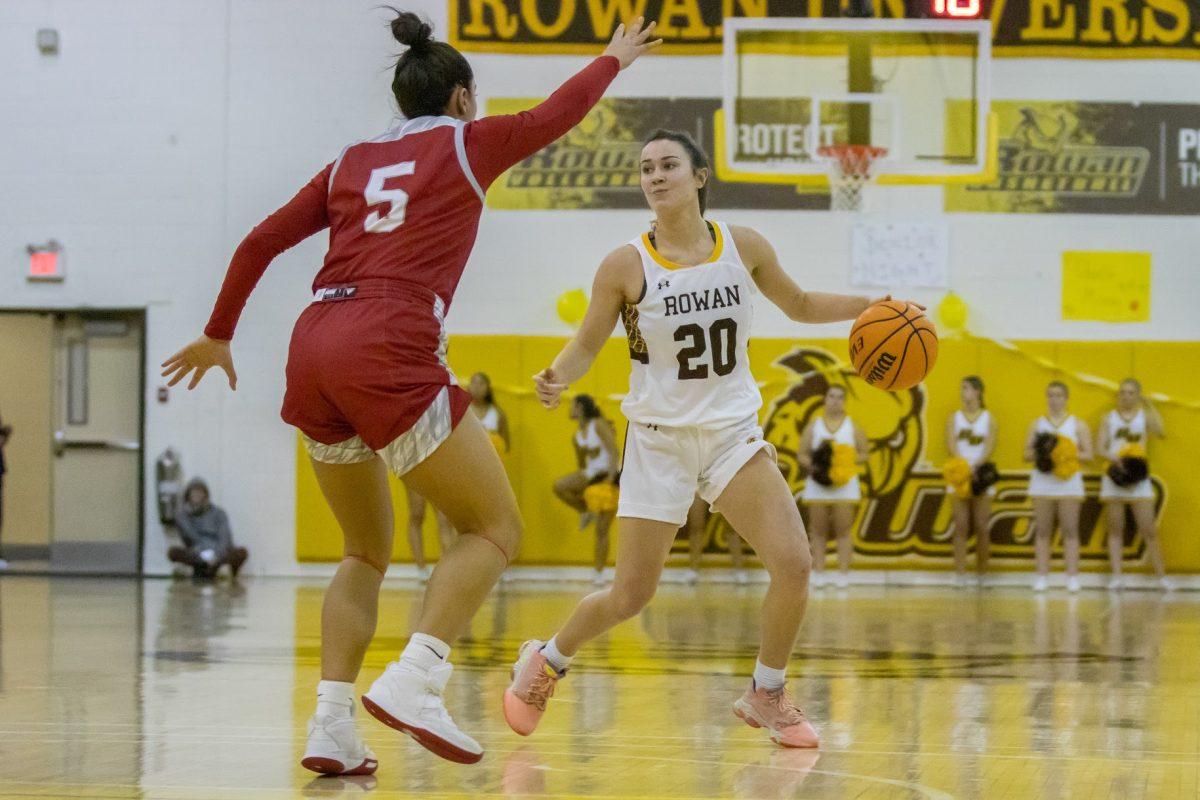 Kate Herlihy dribbles the ball in front of a defender. Herlihy contributed 12 points off the bench against Kean. Wednesday, Feb. 15, 2023. - Multimedia Editor / Lee Kotzen 