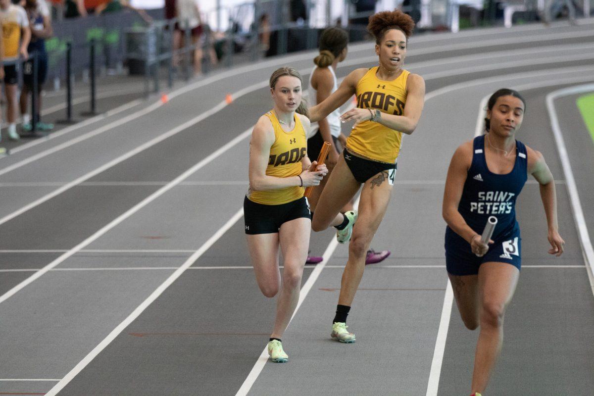 Jasmine Broadway passes the baton to Kat Pedersen during the 4x400. Pedersen had season bests in multiple races this weekend. Friday, Feb. 3, 2023. - Photo / Dom Francesconi via Rowan Athletics