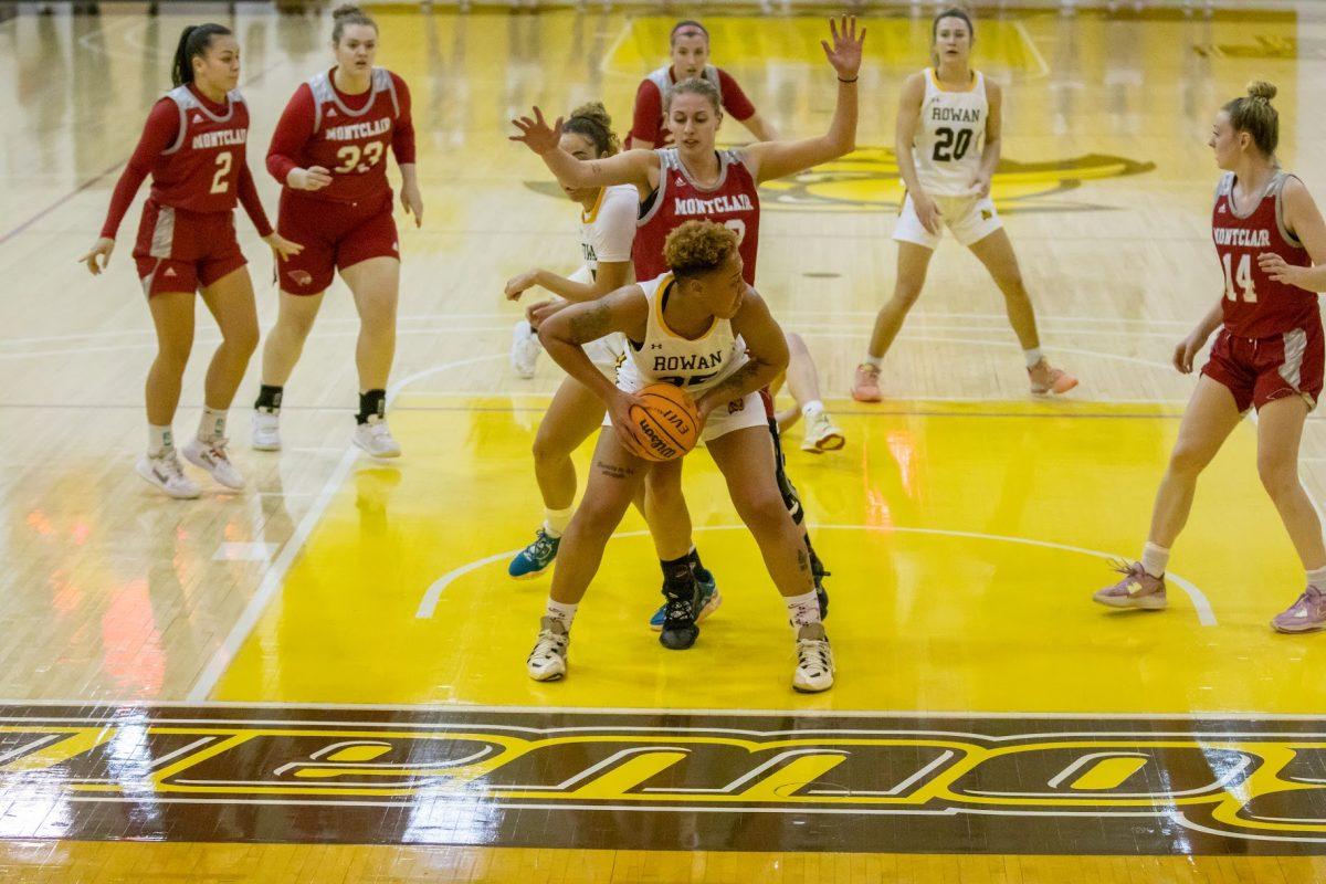 Ayanna Johnson maintains control of the ball surrounded by Montclair State University Players. Wednesday, Feb. 17, 2023. - Multimedia Editor / Lee Kotzen