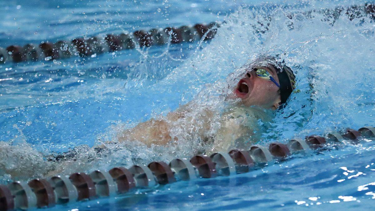 Jack Watson swims in a race. Watson got first in the 100 backstroke. - Photo / Rowan Athletics