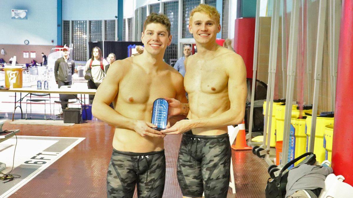 Jack Watson and Alex Volin hoist the third place trophy. - Photo / Rowan Athletics