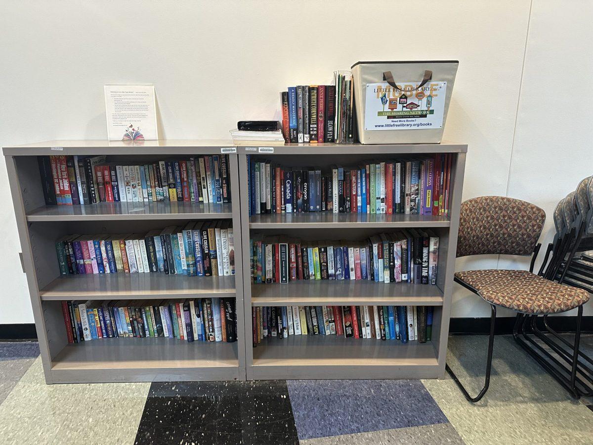 The six little shelves of the Little Free Library is filled with books that students can take. - News Intern / Connor Brown