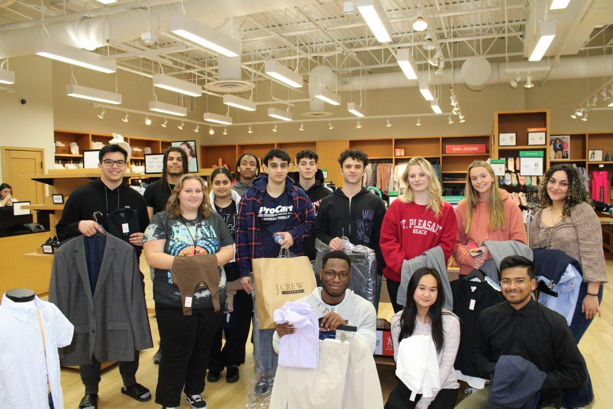 Fourteen of the 50 selected students pose with their new, free business attire from J. Crew in the Gloucester Premium Outlets. - Photo via Bryan Emery