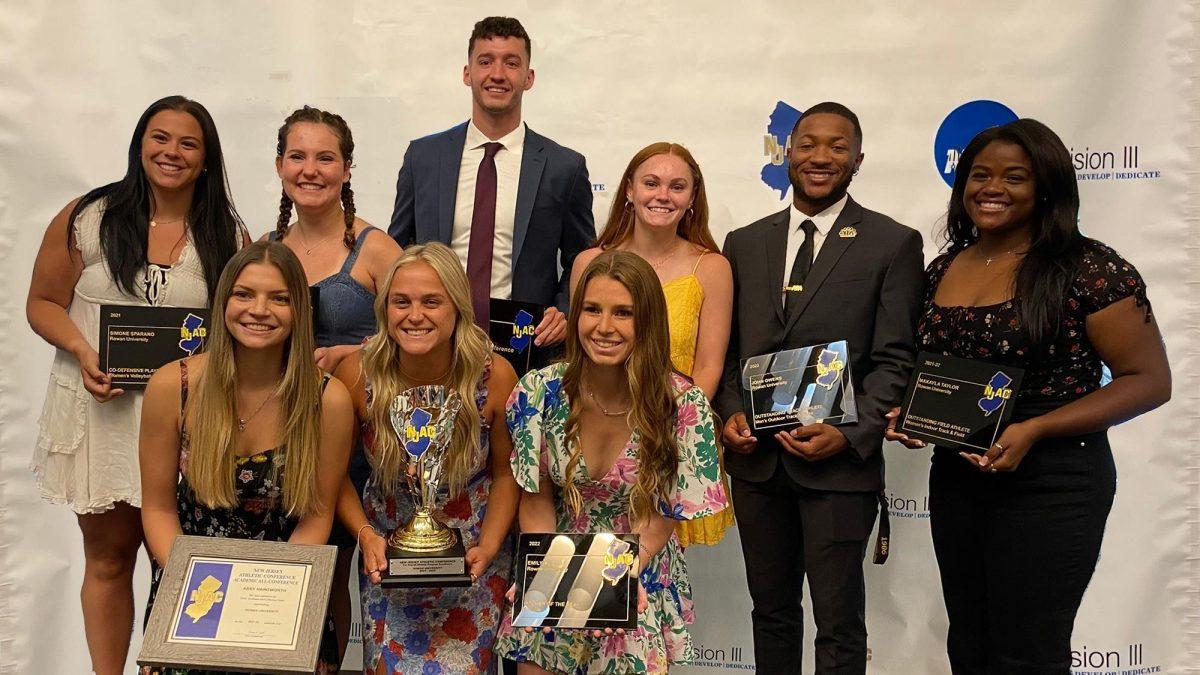 Several Rowan athletes stand together at the NJAC Awards Brunch after accepting the NJAC Cup on Rowan's behalf, the league's all-sport award for overall success. This was the fourth time in five years that Rowan was awarded the cup. June 12, 2022 - Photo / Rowan Athletics