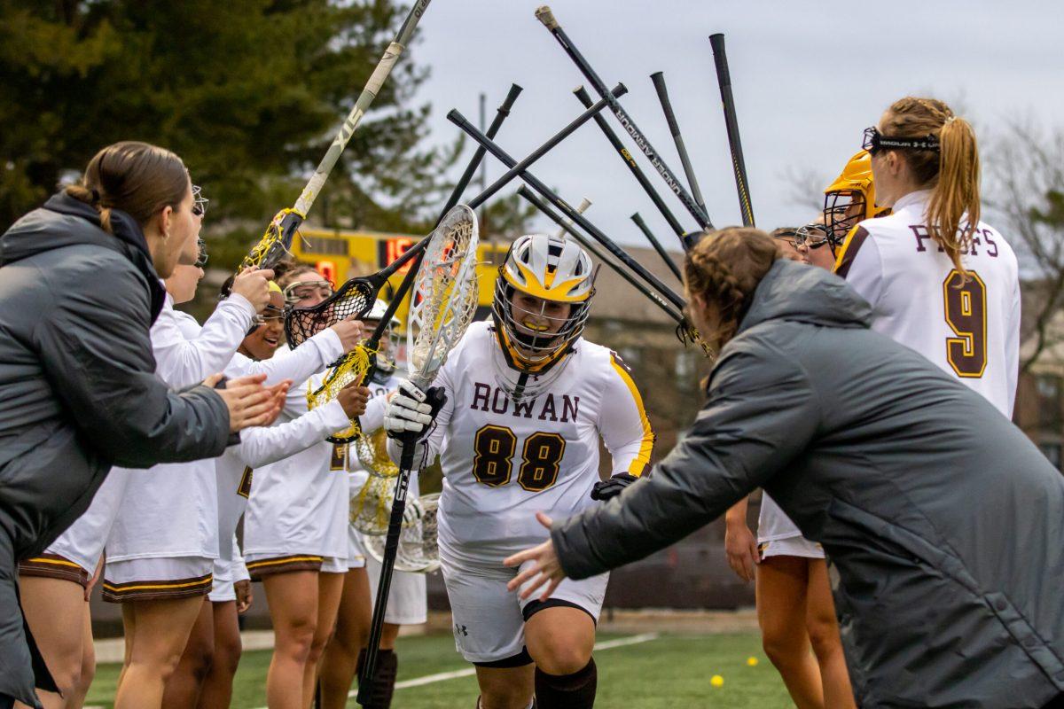 Reilly Shaup runs out onto the field. Shaup is set to be the starting goalie this season. Wednesday, March 1, 2023. - Multimedia Editor / Lee Kotzen