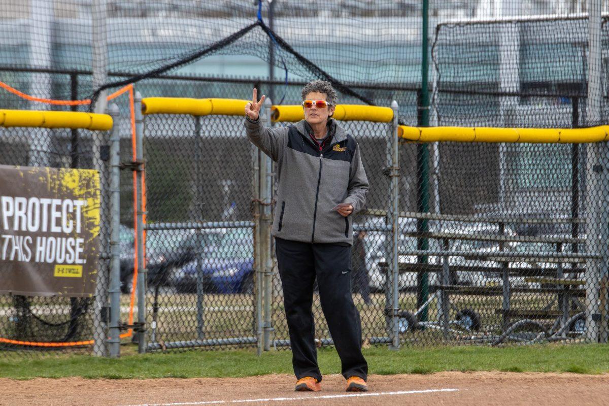 Head Coach Kim Wilson coaches from the third base side. Coach Wilson is set to be inducted into the National Fastpitch Coaches Association's Hall of Fame. Wednesday, March 30, 2022. - Multimedia Editor / Lee Kotzen