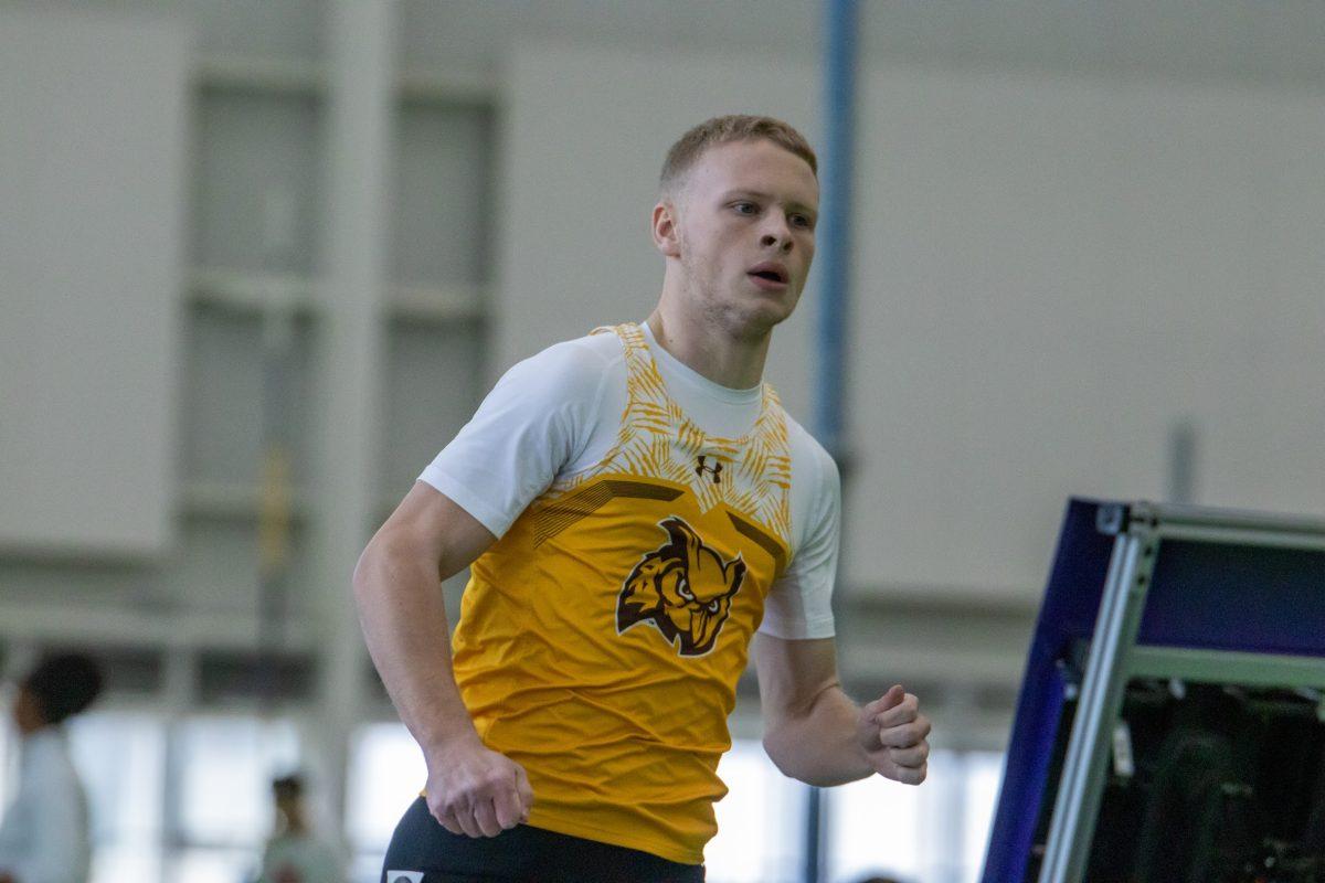 Evan Corcoran runs in a race. Corcoran was one of the members of the record-setting 4x200 team. Friday, Feb. 3, 2023. - Multimedia Editor / Lee Kotzen