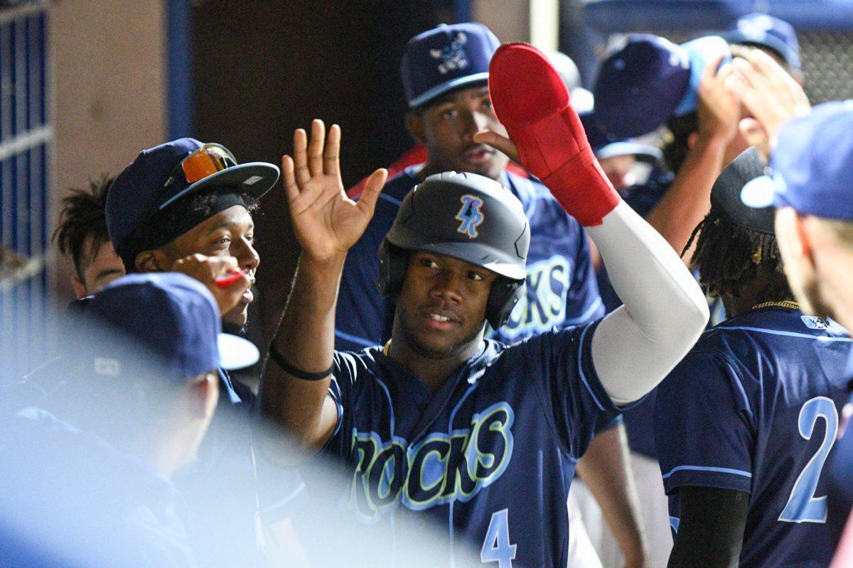 Jeremy De La Rosa is congratulated in the Blue Rocks dugout following his run scored. Wednesday April 12th, 2023. - Staff Photographer / Tyrese Williams