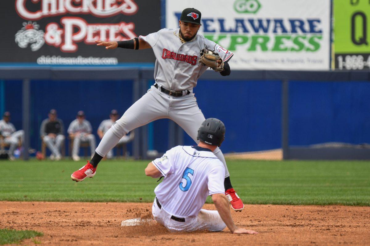 Crawdads shortstop Max Acosta leaps over Blue Rocks catcher Matt Suggs at second base. Sunday, April 16th, 2023. Staff photographer / Tyrese Williams