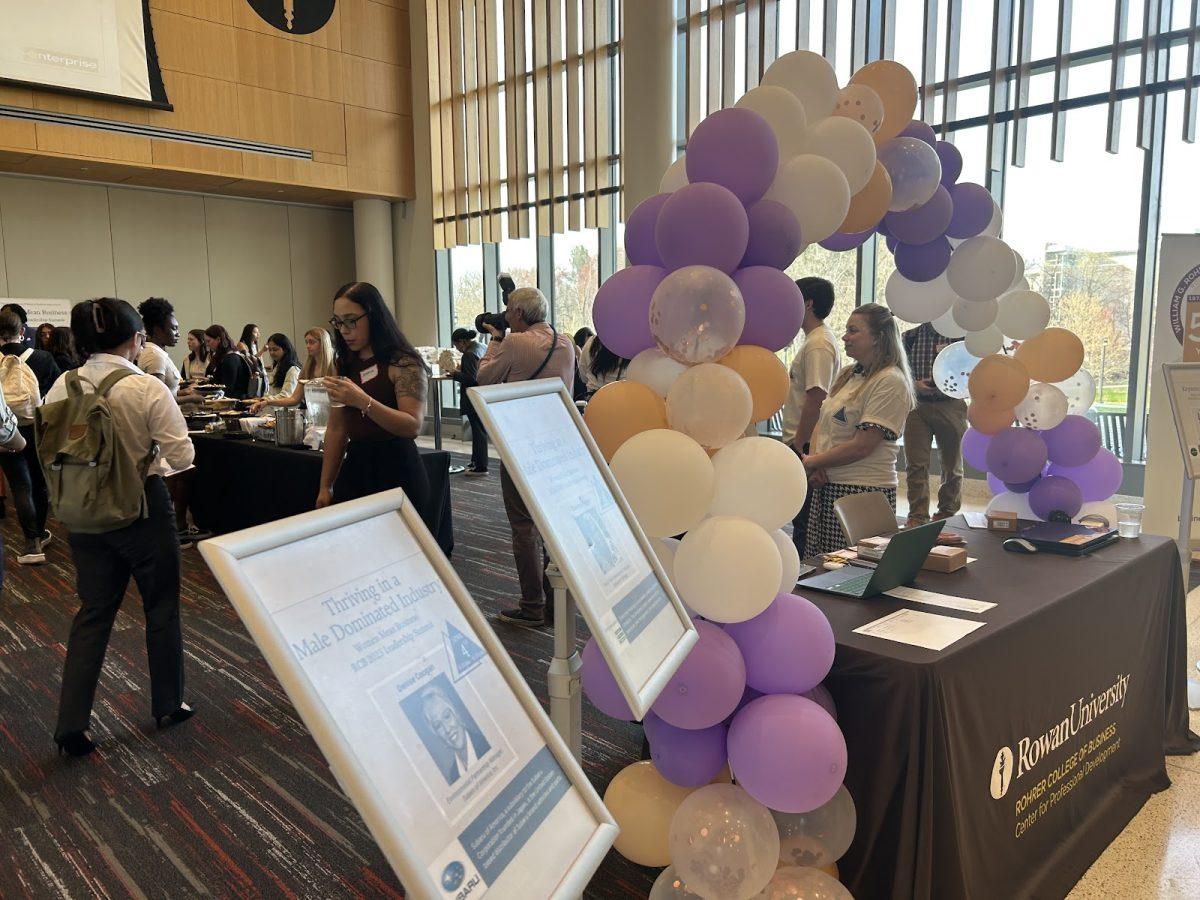 Attendees check into the hub at the balloon arch in Business Hall for the Women’s Leadership Summit on Tuesday evening, April 4, 2023. - Photo / Maryela Gallardo 