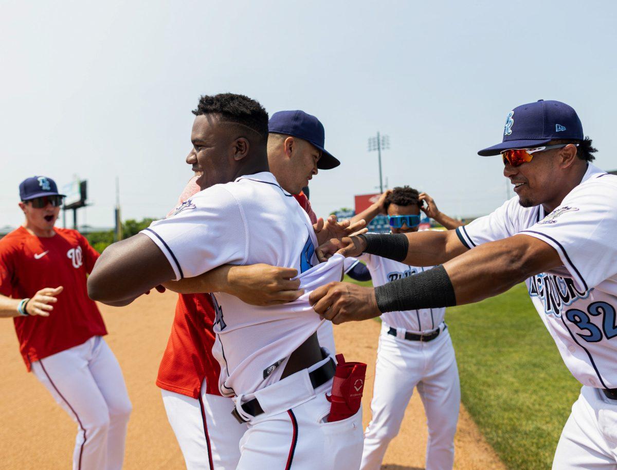 Jeremy De La Rosa is swarmed by teammates after his walk-off RBI single in the 10th inning and completing the comeback. Wednesday, May 24, 2023. Staff Photographer / Joe Capuyan