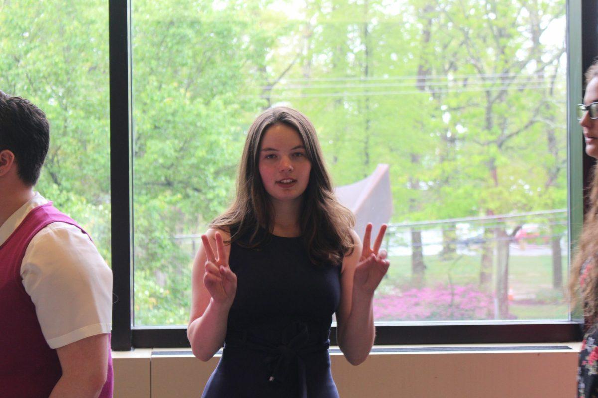 Whit Editor in Chief Victoria McGivern throws up piece signs in the Eynon Ballroom. - Staff Photographer / Josh Ayers