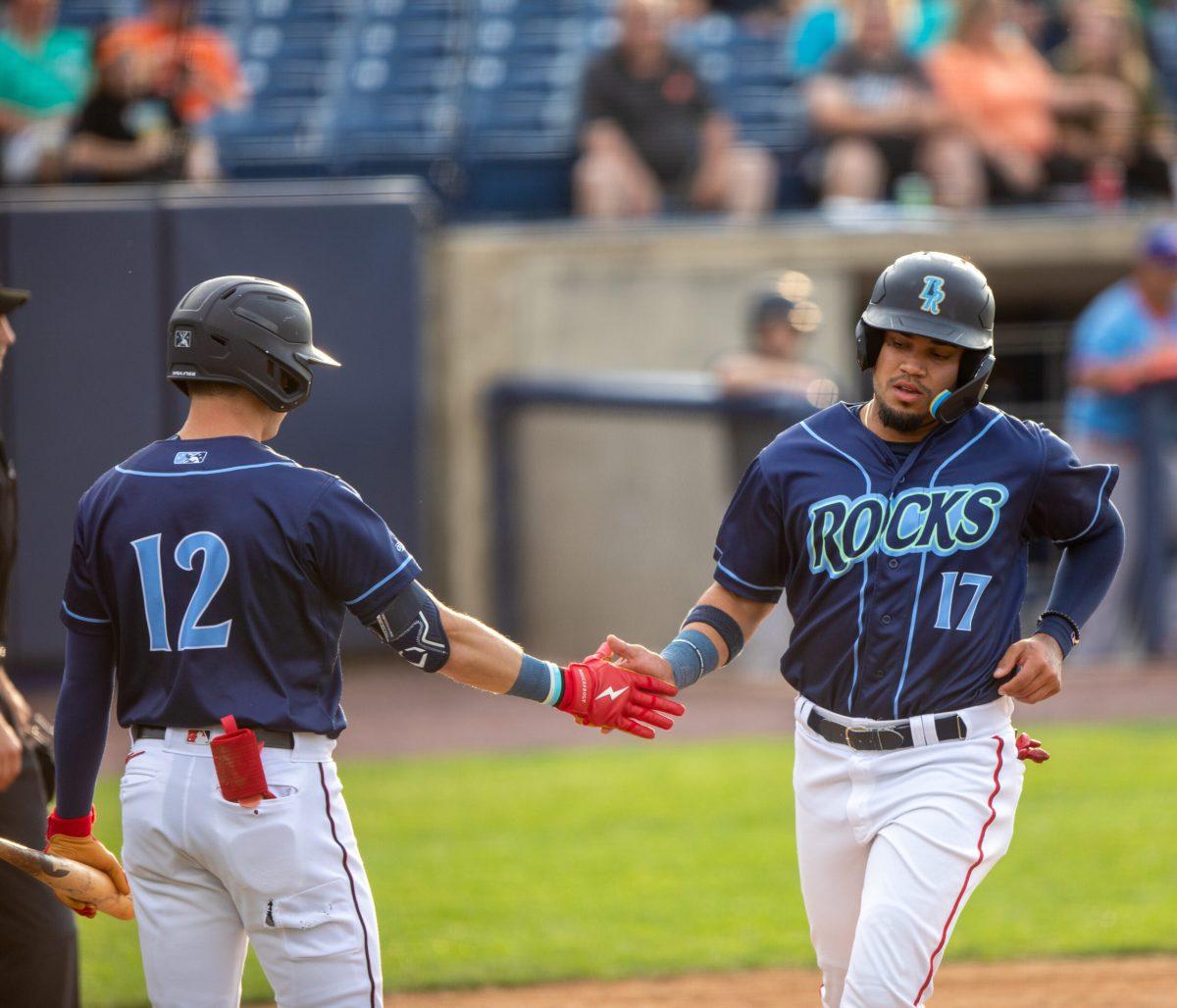 Jared McKenzie daps up Jose Sanchez as he crosses home plate. Tuesday, June 20, 2023. Staff Photographer / Joe Capuyan