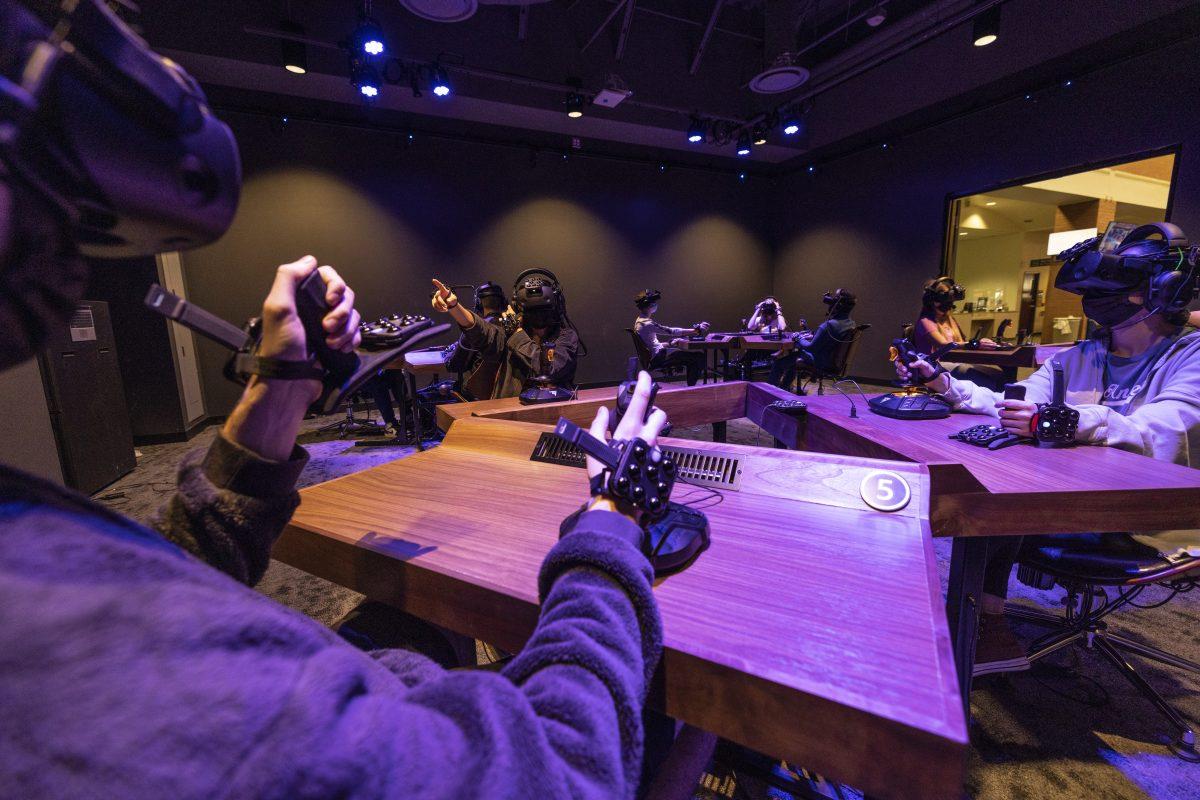 Students explore a virtual world while seated at desks in an immersive learning center pod at Arizona State University. Photo provided courtesy of Arizona State University. - Photo via Rowan University press release