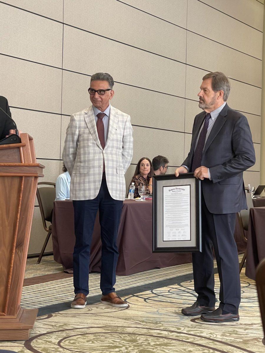 President Houshmand presents Larry Salva with a document of certification for his donation at the Board of Trustees meeting on Sept. 13. - Co-News Editor / Gianna Malgieri