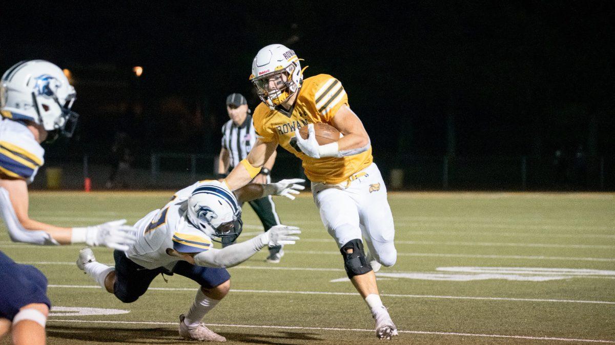 James Fara stiff arms a defender. Fara recorded a career-high 203 rushing yards against Johns Hopkins. - Photo via Rowan Athletics