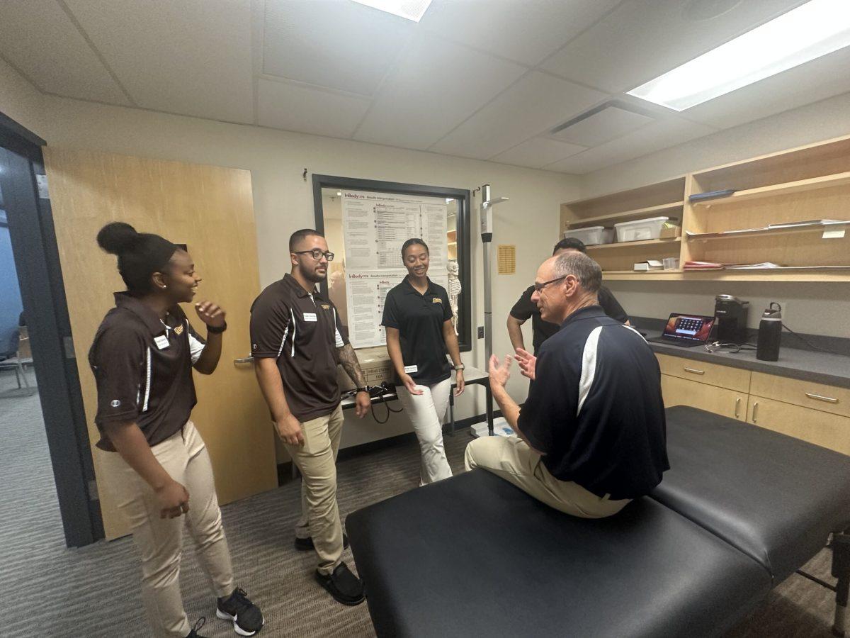 Dr. Mann directs athletic students before their first satellite office where they can shadow the physician while they treat patients with atheltic-related injuries, nerve and/or concussion issues. - Multimedia Editor / Drew Peltzman 