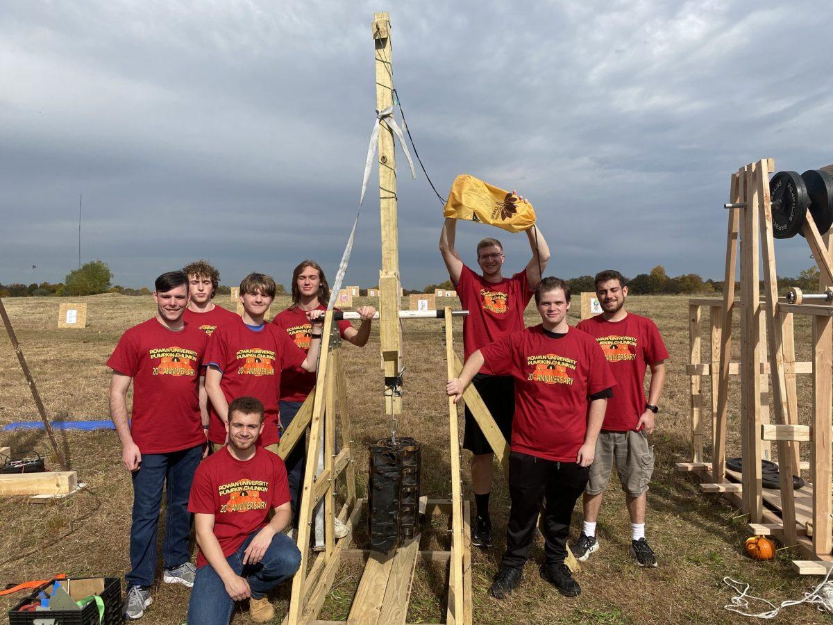 American Society of Mechanical Engineers poses with their trebuchet. - Staff Writer / Paige Britt