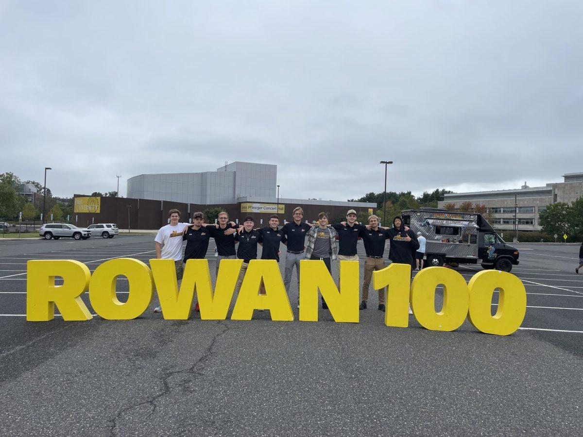 Rowan's Men's Swim Team poses with centennial decoration. - Contributor / Brendan Cohen