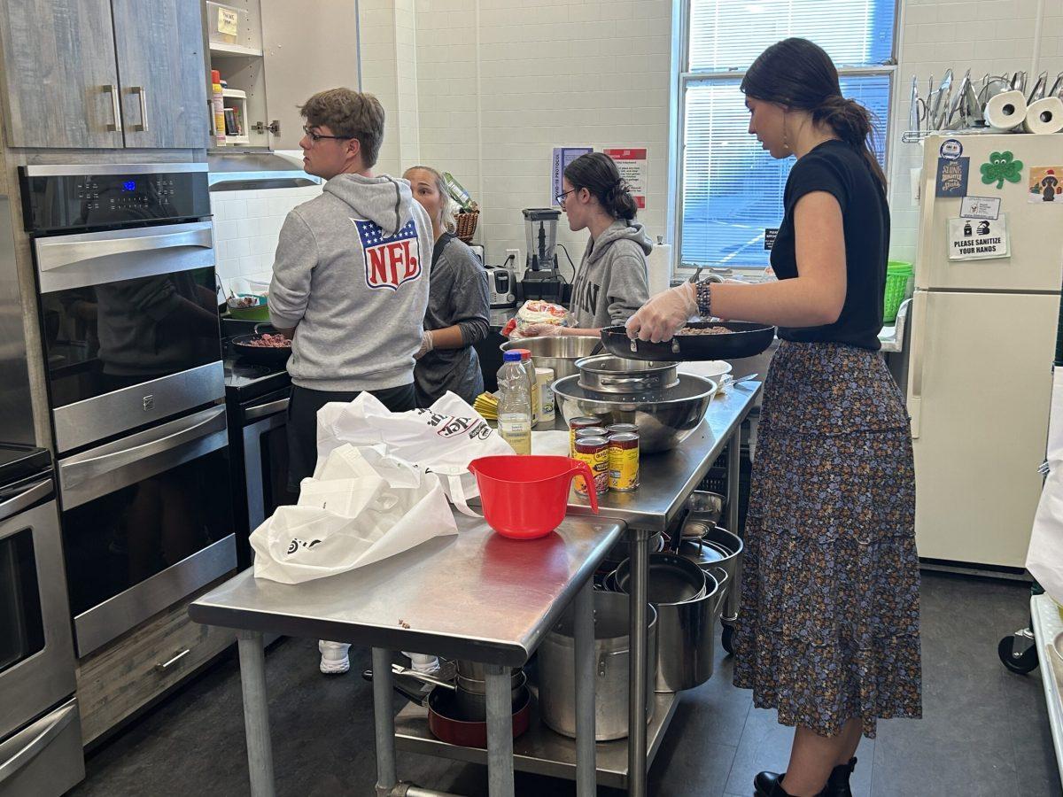 Student volunteers prepare dinner in The Ronald Mcdonald House kitchen. - Contributor / Shane Bagot