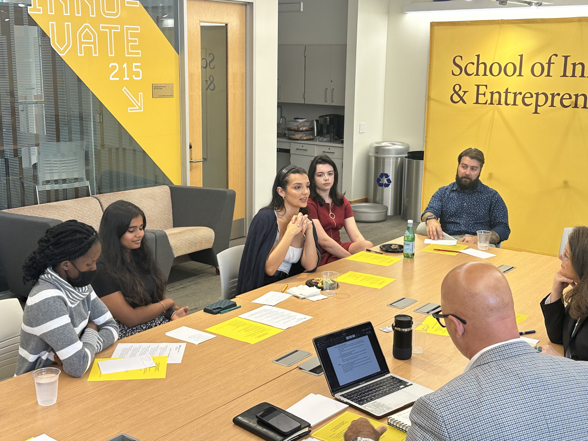 Fellows meet with Dean Jennifer Maden and Lead Mentor Greg Payton in the Rowan Center for Innovation and Entrepreneurship. - Photo via Christina Veach