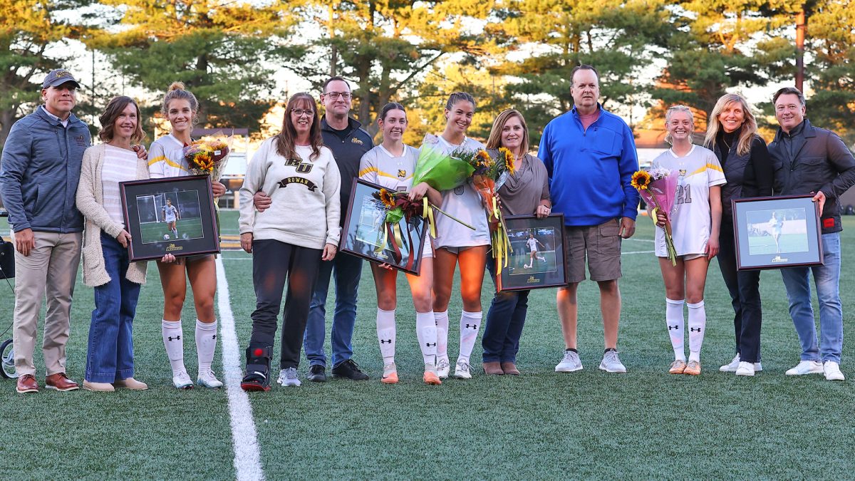 (Left to right) Emma DeMaise, Gabby Dean, Sarah Bergan, and Emily Casale get honored with their families pregame for Senior Night. - Photo via Rowan Athletics