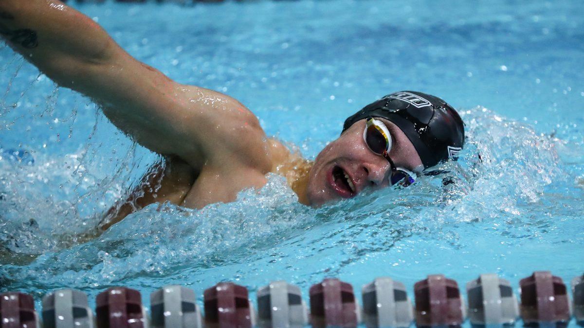 Tobias Cahnbley swims in a meet. Cahnbley, along with Jack Watson and Michael Fracchiolla, recorded three first place finishes during the meet. - Photo via Rowan Athletics