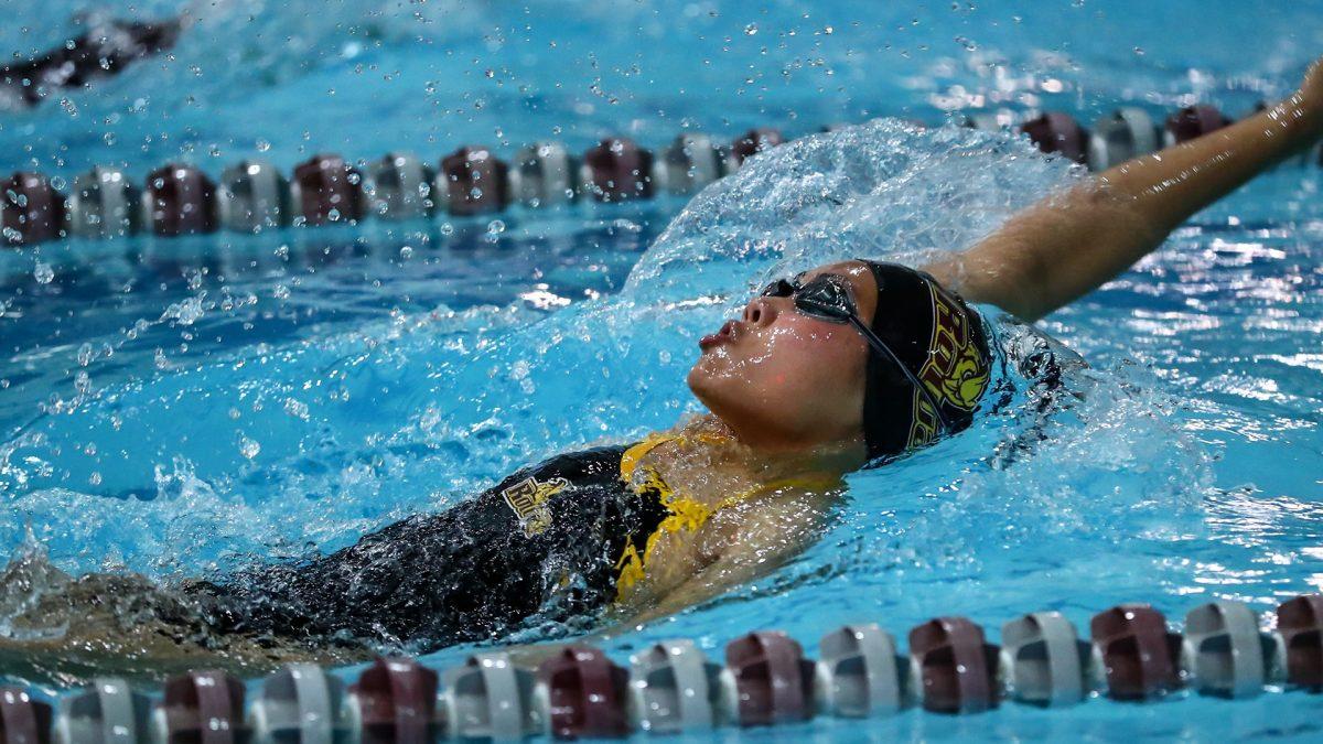 Trisha Lau races in the backstroke. Lau has gotten off to a fast start this season and is an integral part of the Rowan Women's Swimming team. - Photo via Rowan Athletics