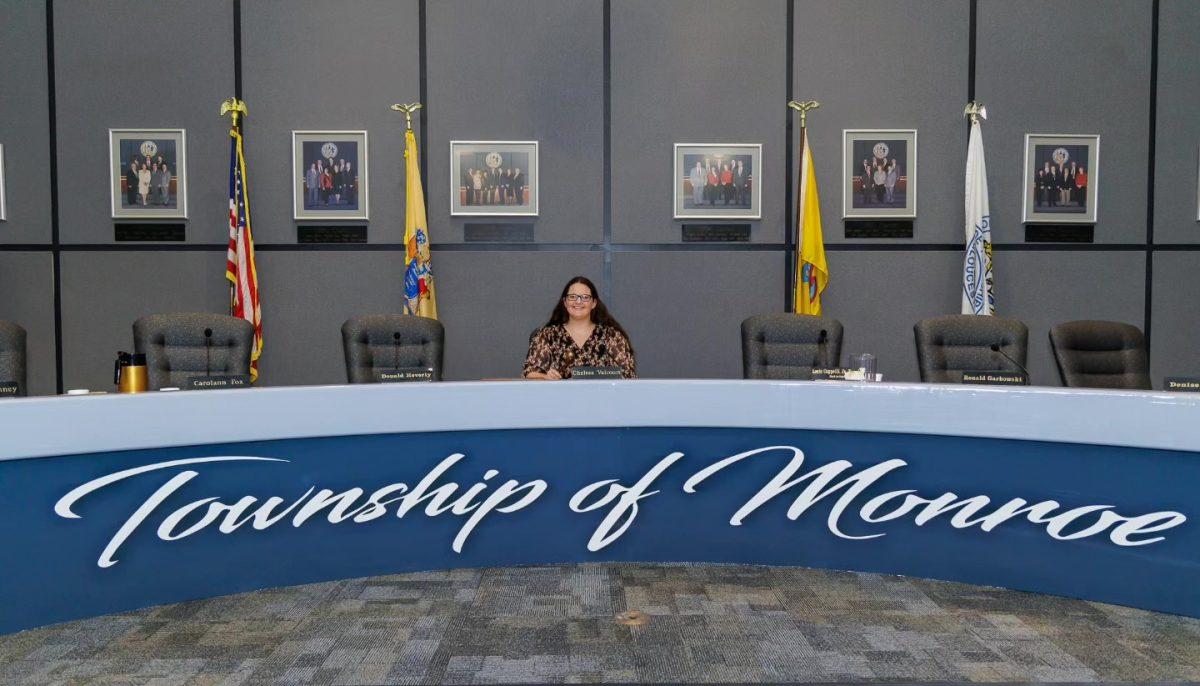 Chelsea Valcourt poses for a photo in the town meeting hall. - Photo via Mike Hickman Photography