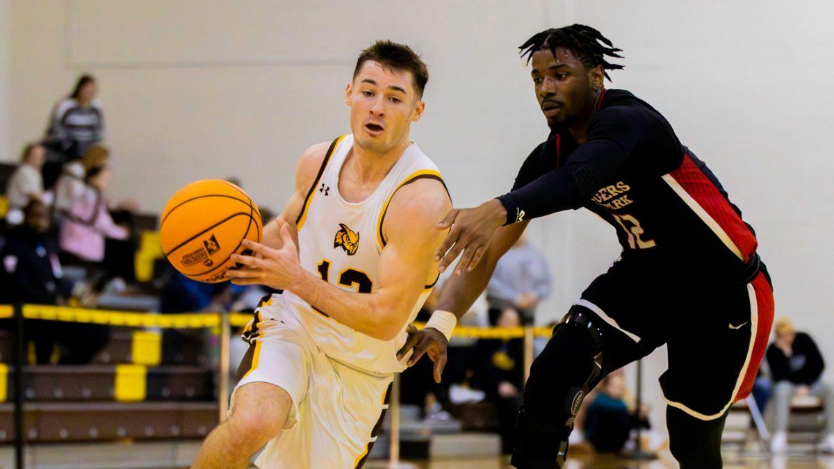 Chris McCarron drives inside for a layup. McCarron recorded 15 points and helped anchor a Profs' defense that only let up 76 points. - Photo via Rowan Athletics