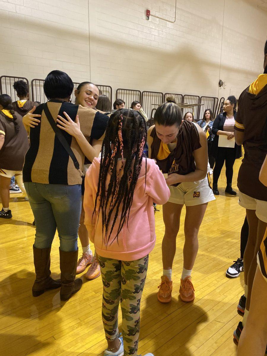 Junior, Kate Herlihy, meets a young basketball layer who came out for the event. - Contributor / Riley Adams