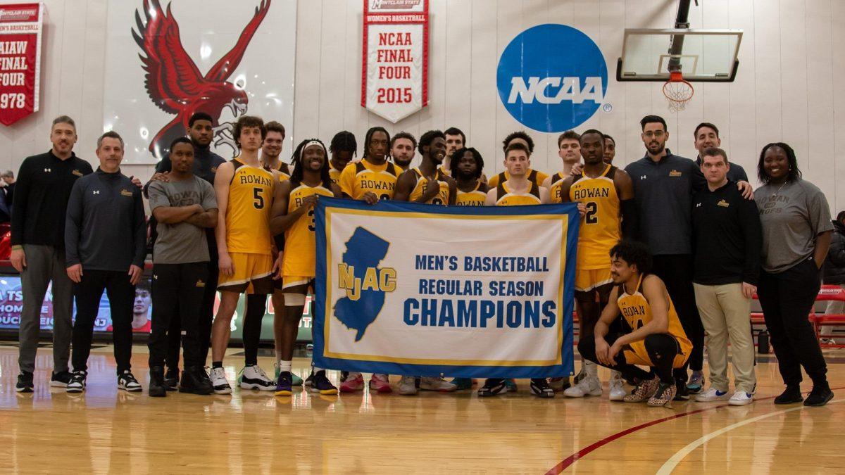 Rowan men's basketball holds up the regular season NJAC champion banner. Rowan will host TCNJ in the semifinals of the NJAC playoffs on Wednesday, Feb. 21. - Photo via Rowan Athletics