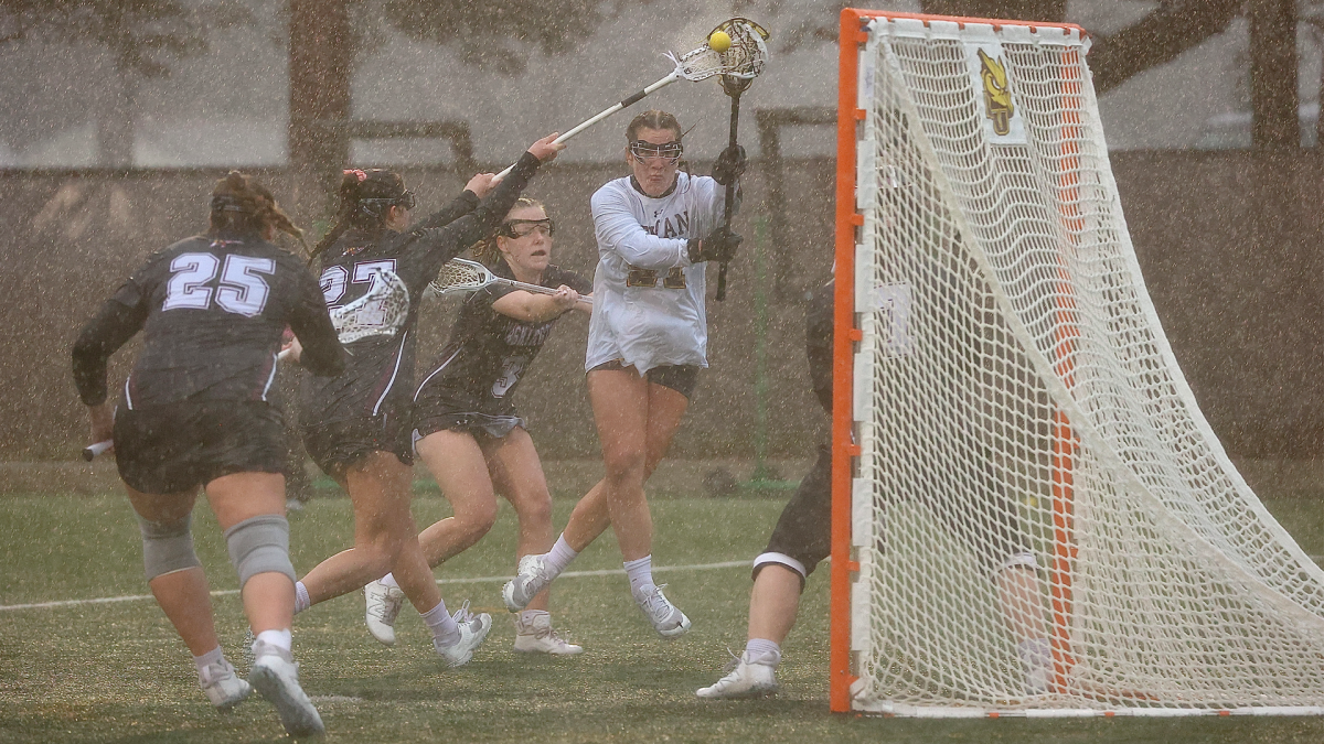 Calista Burke attacks the net. Burke recorded a season-high four goals in the loss. - Photo via Rowan Athletics