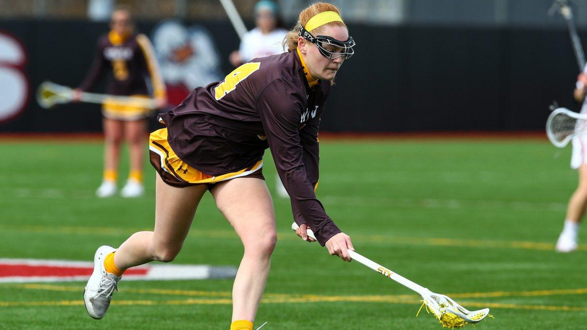 Molly Green picks up a ground ball. Green recorded her 100th career goal in the win over Stockton. - Photo via Rowan Athletics