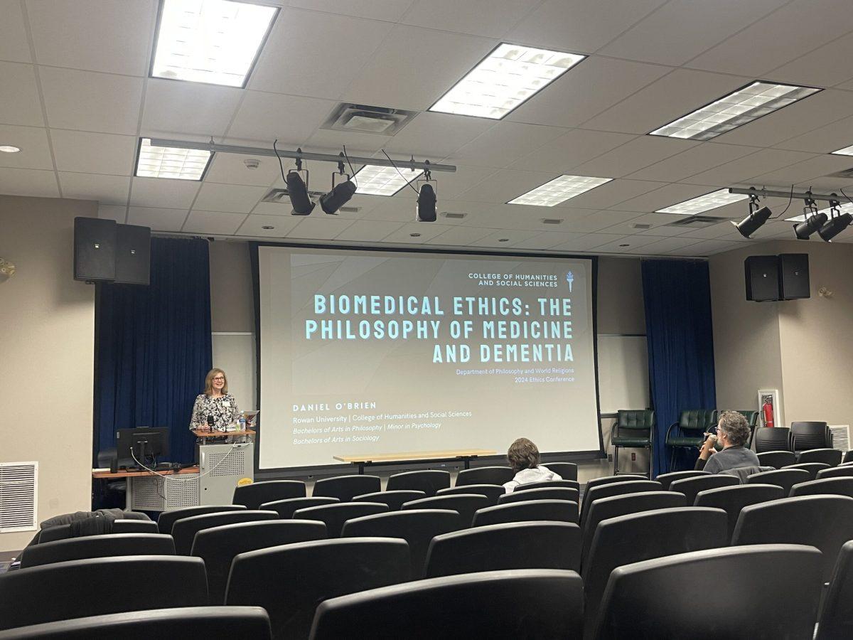 Student Ethics Conference coordinator Dr. Ellen Miller introducing Rowan student Daniel O’Brien’s research study, “Biomedical Ethics: The Philosophy Of Medicine And Dementia.” - Staff Writer / Marchella Mazzoni