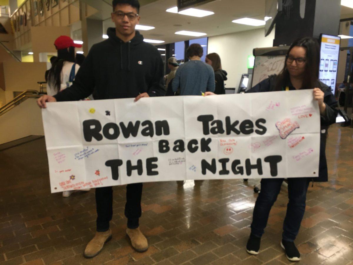 Wellness Center staff prepares to walk banner out during Take Back the Night on April 2. - Managing Editor / Abigail Twiford