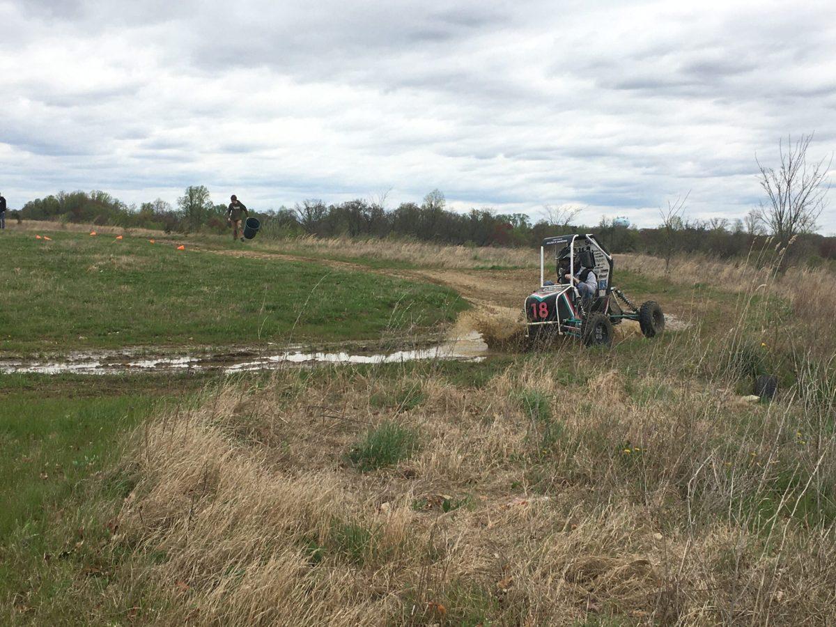 Baja car is test driven around the muddy track. - Managing Editor / Abigail Twiford