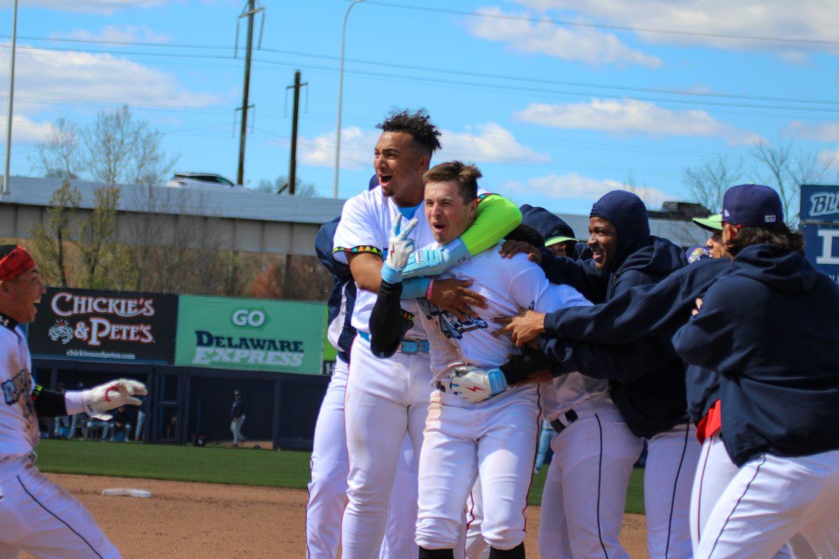 The Blue Rocks swarm Jared McKenzie following his second straight walk-off. - Sunday, April 7, 2024 / Photo via Payton Tuorto