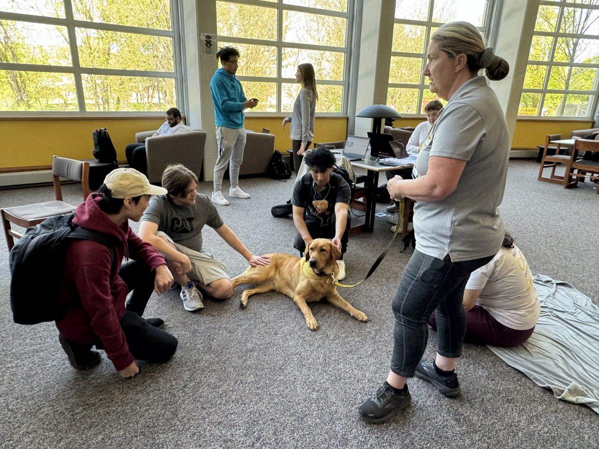 Students petting therapy dog Cinder at Wagging Tail Tuesday. - Productions Editor / Sarah Shockey