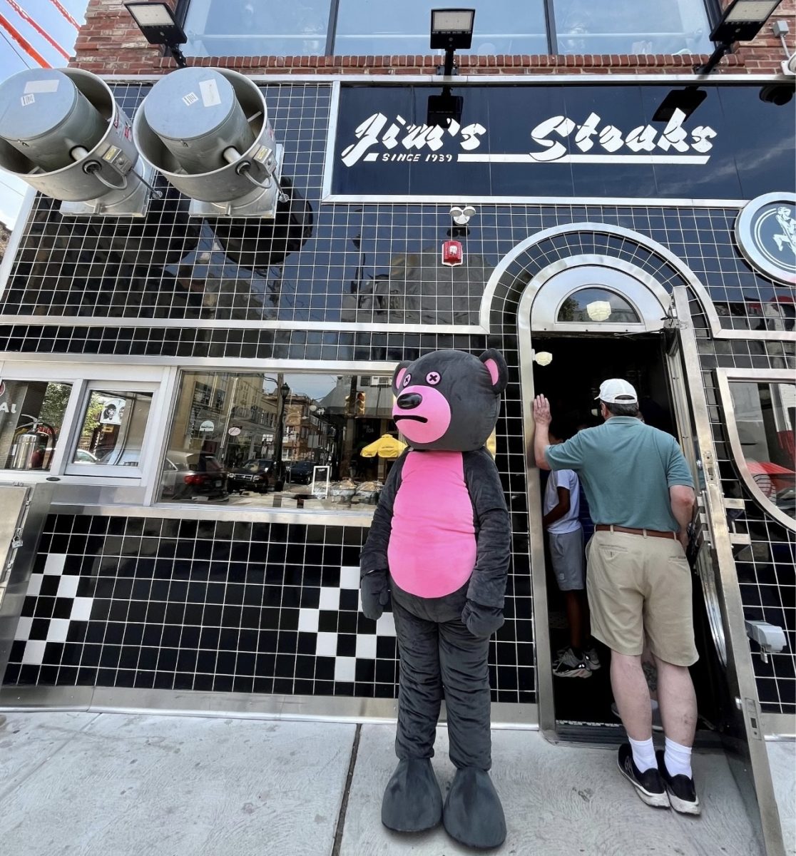 Ellie Gressman promoting the Sad Summer Festival in a bear costume outside of Jim’s Steaks. - Photo via Ellie Gressman