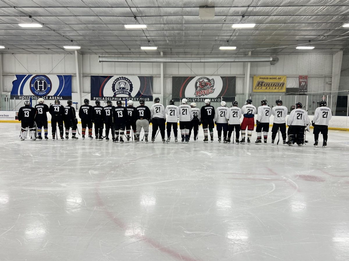 Guy Gaudreau's friends wearing Matthew's (21) and Johnny's (13) jersey at the Hollydell Ice Arena. - Photo via Nicole McCullen