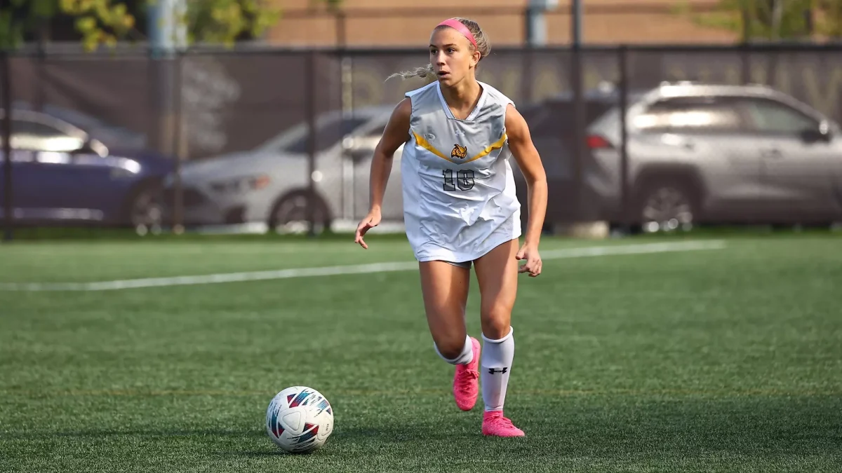 Julianna Giordano brings the ball up the field. Giordano recorded a goal and assist in the shutout win. - Photo via Rowan Athletics